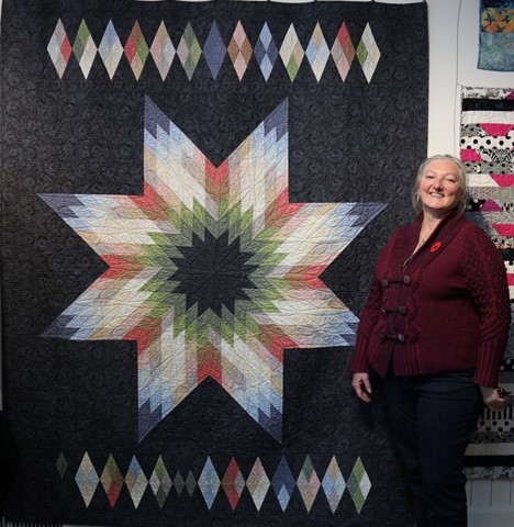 image of Carolyn Mulders and her diamond quilt